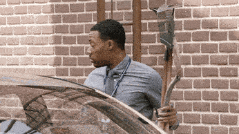 Gif of a man holding gardening tools