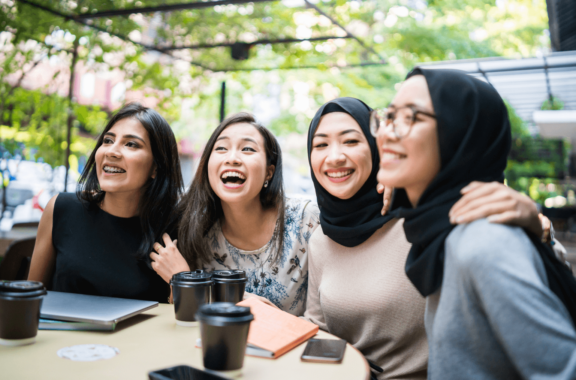a group of women working together and smiling