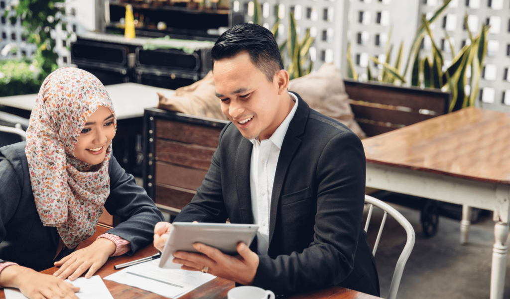 two colleagues discussing something on a tablet