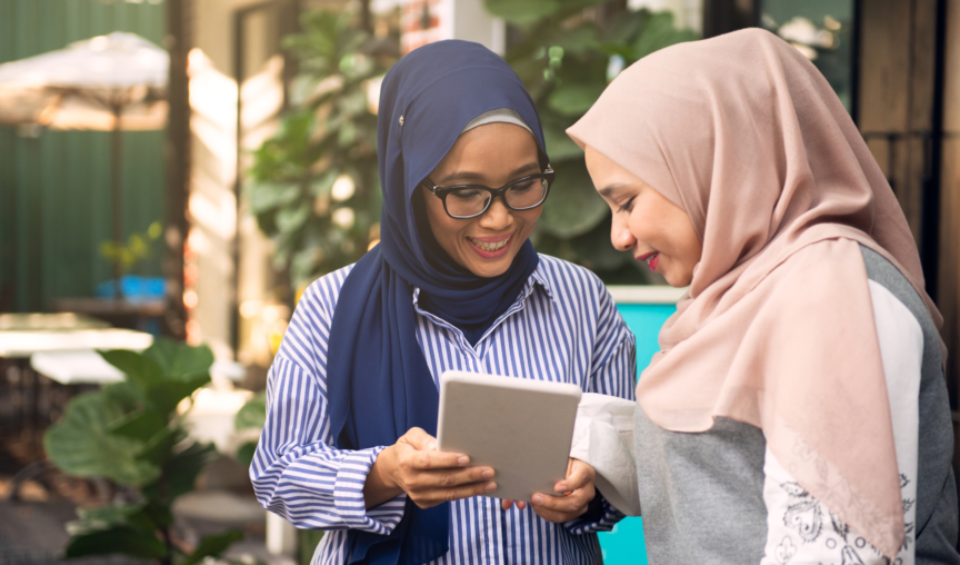two employees happily chatting together