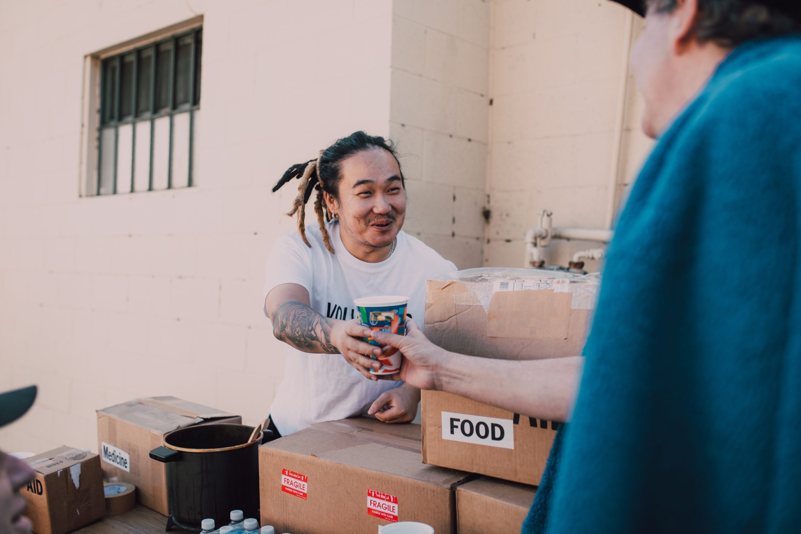 man distributing food to homeless as a volunteer