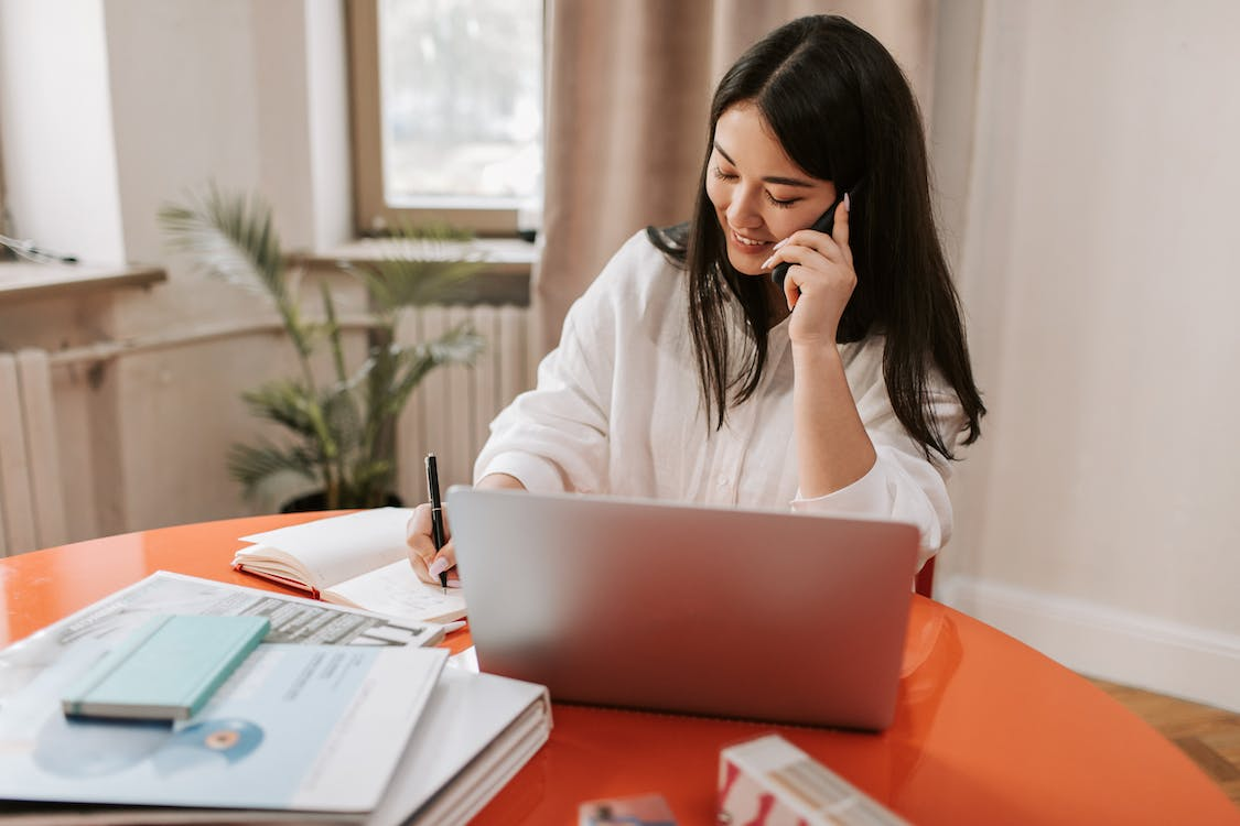 employee on the phone in front of her laptop working