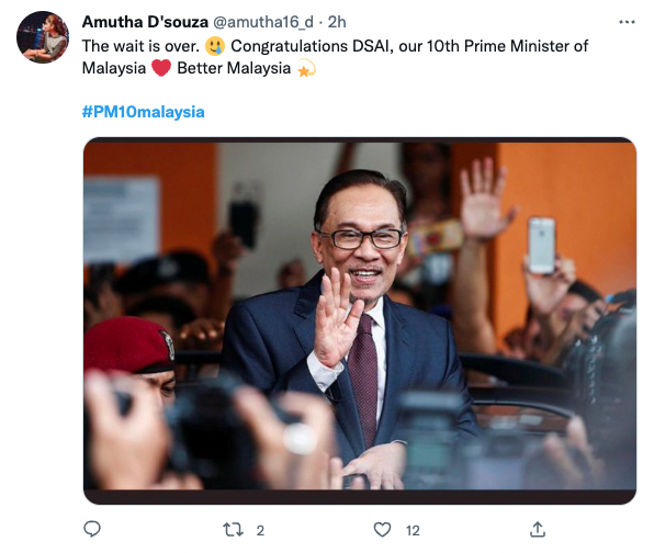 Anwar Ibrahim waving to the press