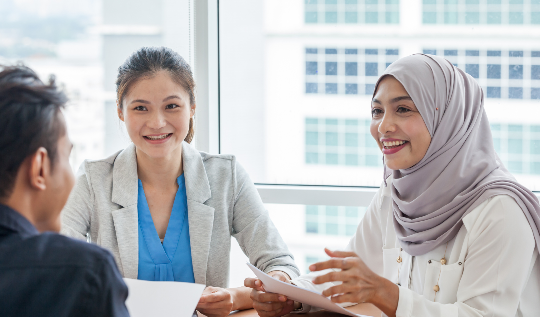 two employees interviewing a potential candidate in the office