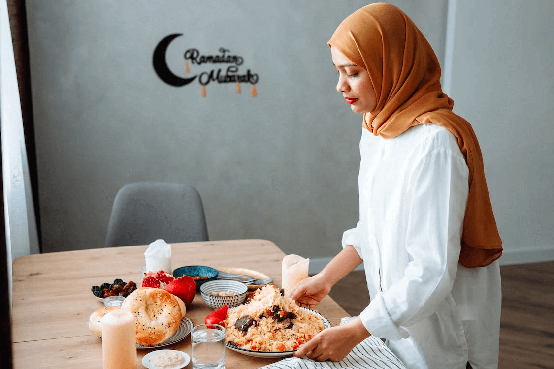woman preparing a feast at the dinner table to break fast