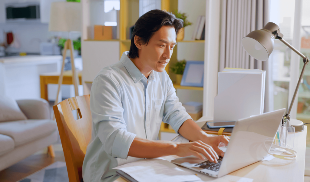 a man doing work on his laptop