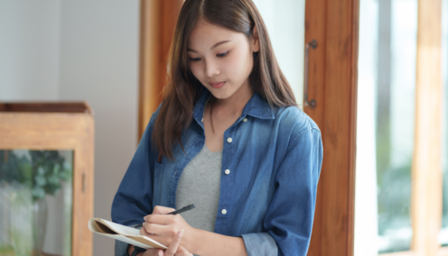 Woman writing on a notepad