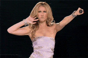 Celine Dion holding a microphone out to her audience