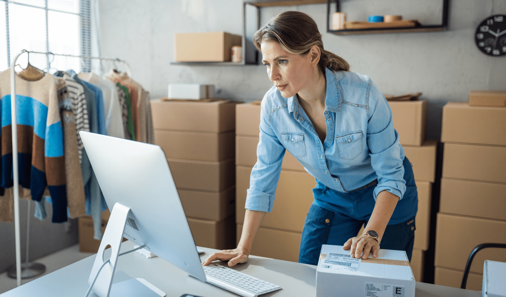 Woman using an imac while running her own business