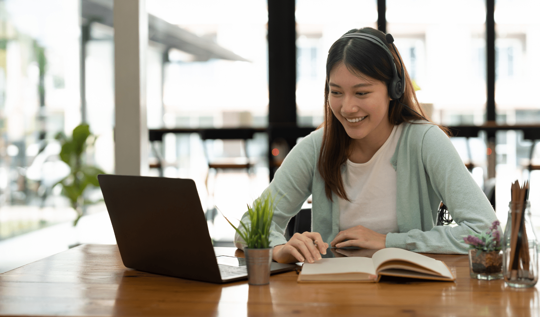 woman attending an online workshop on her laptop and having a good time