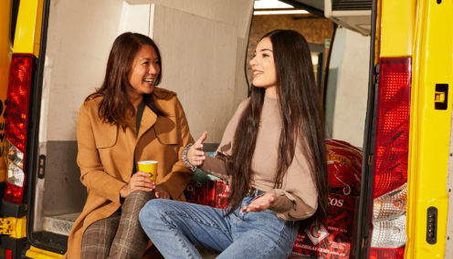 two people speaking in van