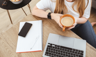 woman sitting at her desk with a coffee - is unpaid work legal