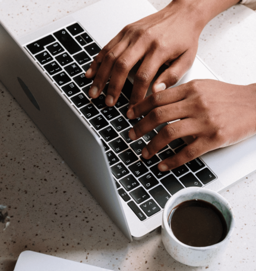 image of a person typing on a laptop