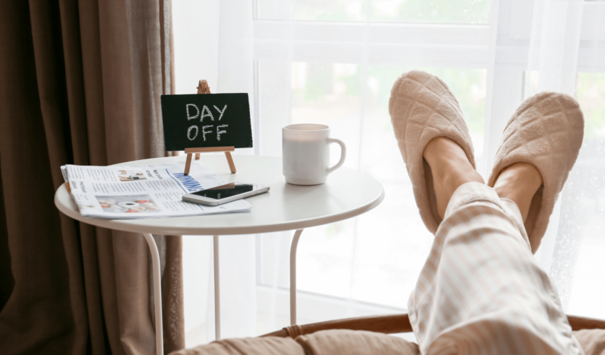 a person with their feet up enjoying their day off next to a table with day off written on a small blackboard