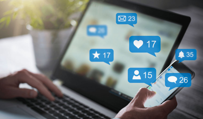laptop with bubbles showing social media interactions