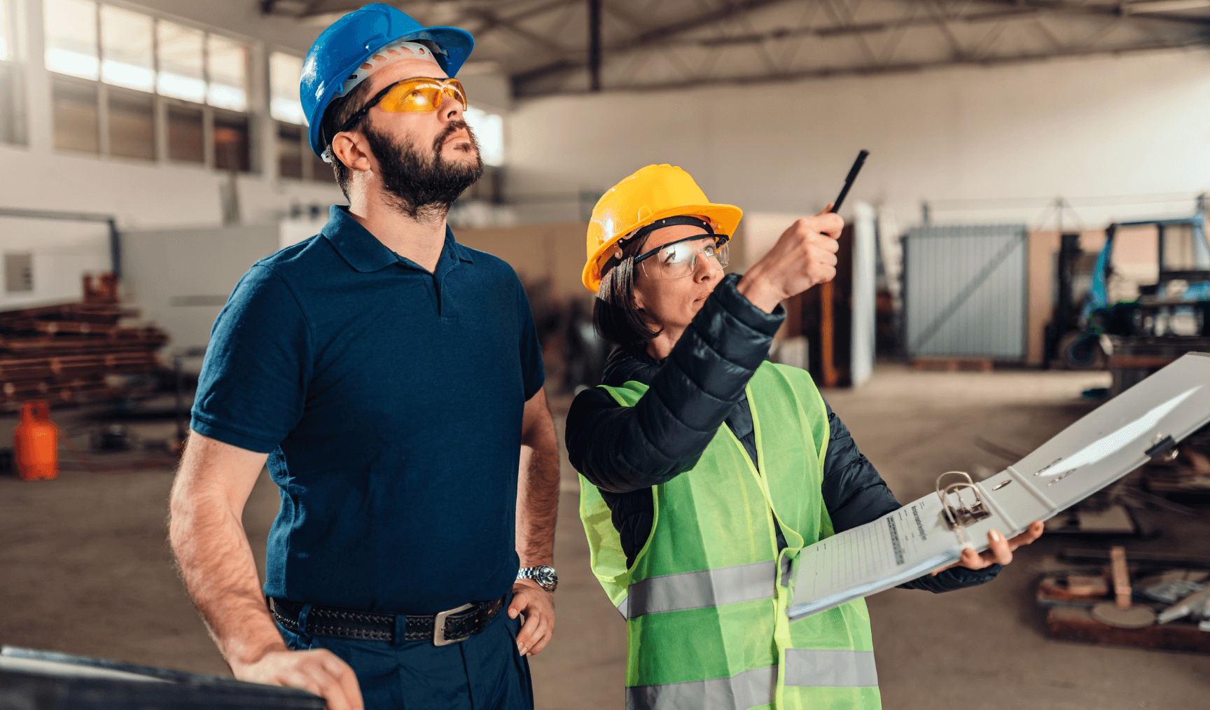 two colleagues pointing at something in the warehouse
