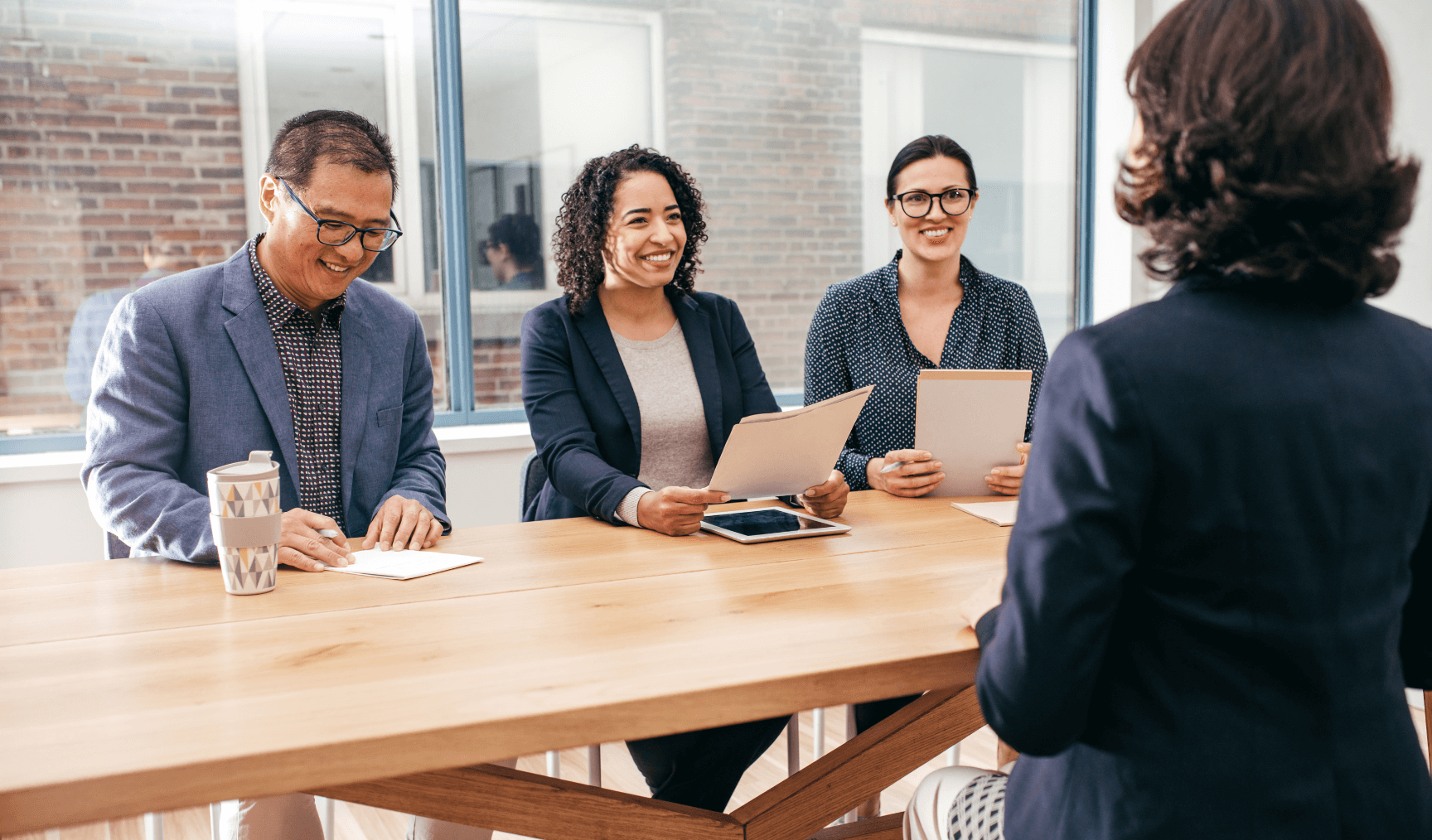 three interviewers speaking with a potential hire