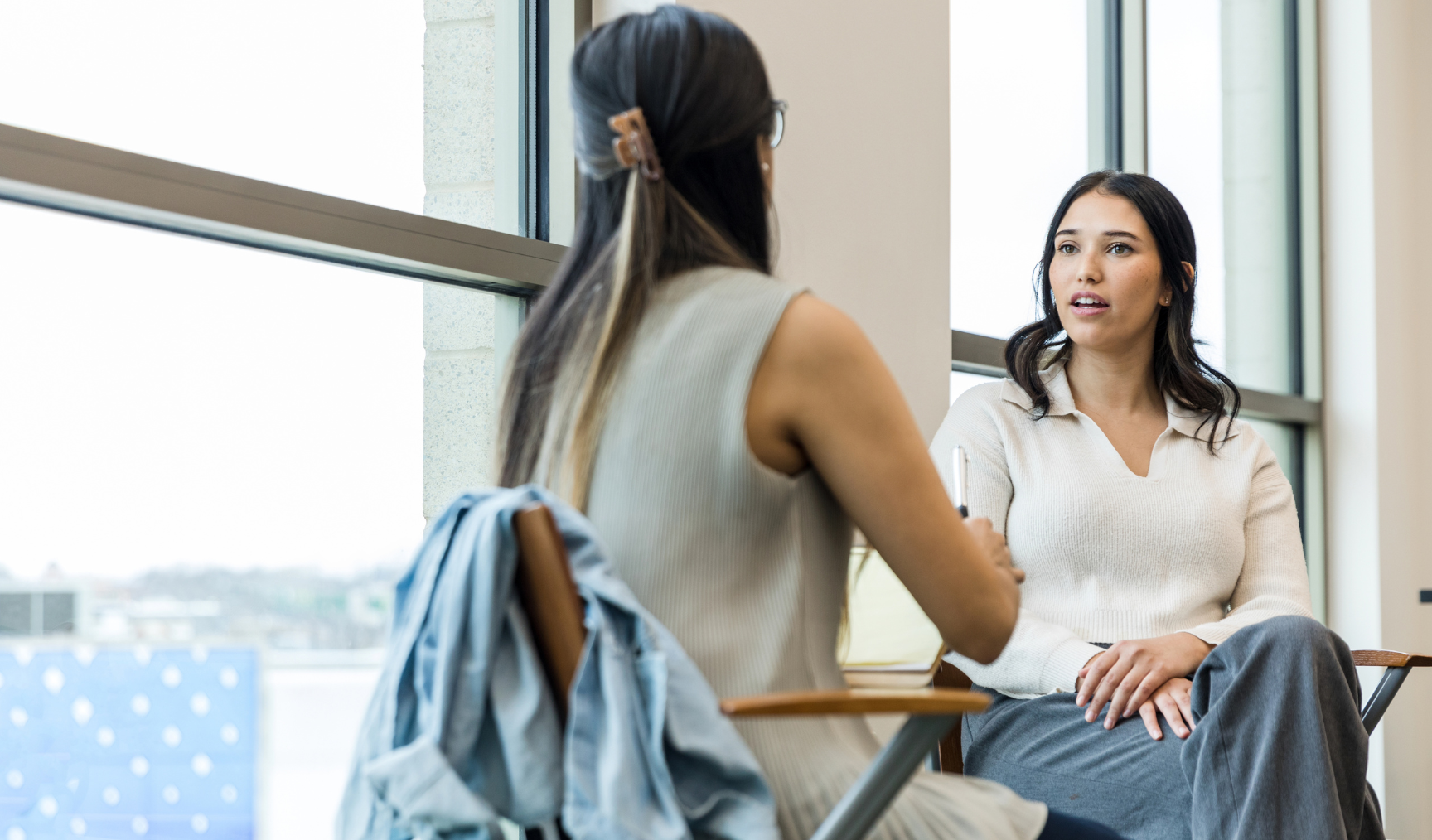 woman speaking to her colleague in the office