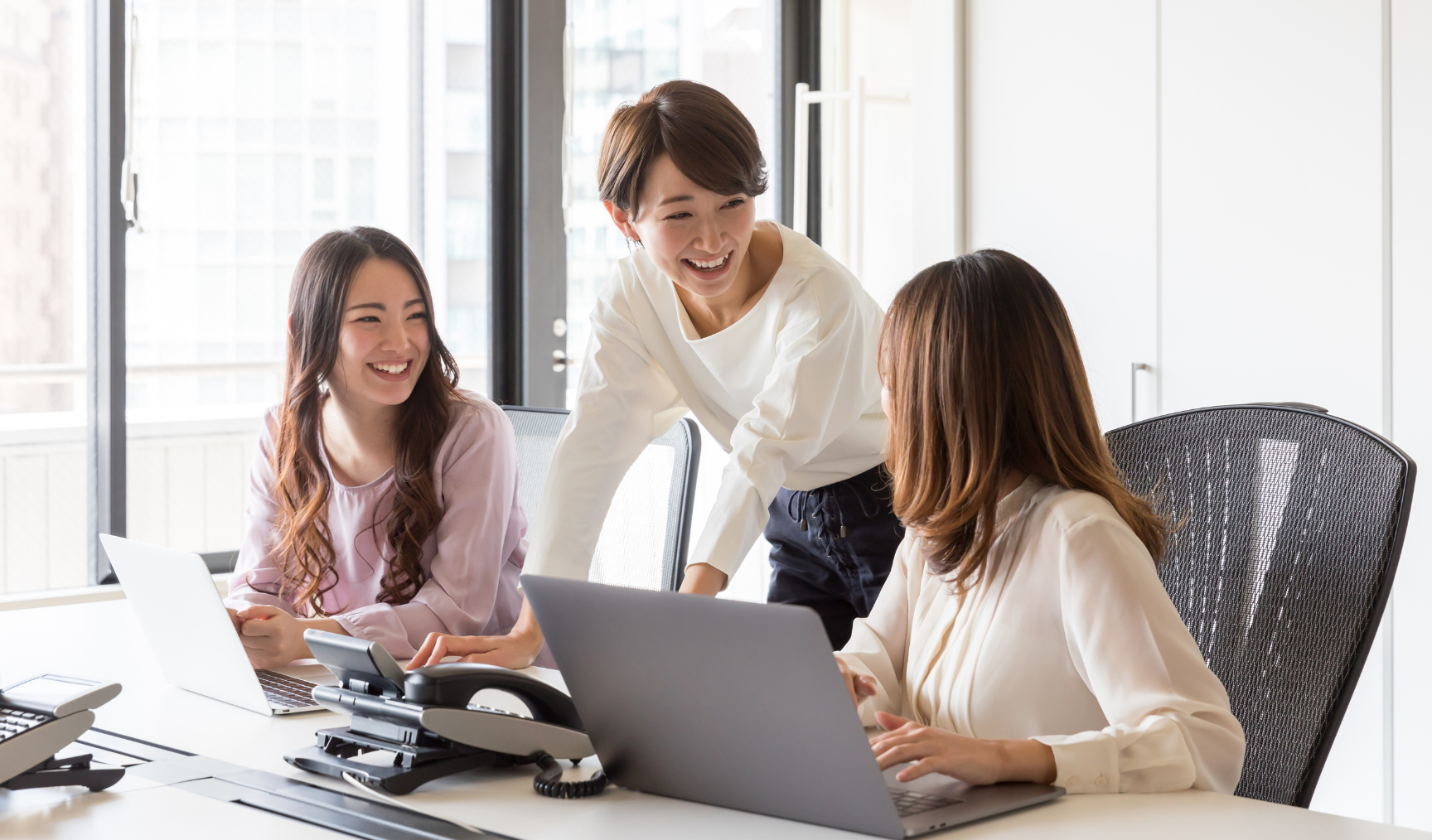 group of female colleagues chatting in the office