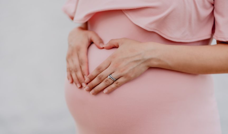pregnant woman holding belly