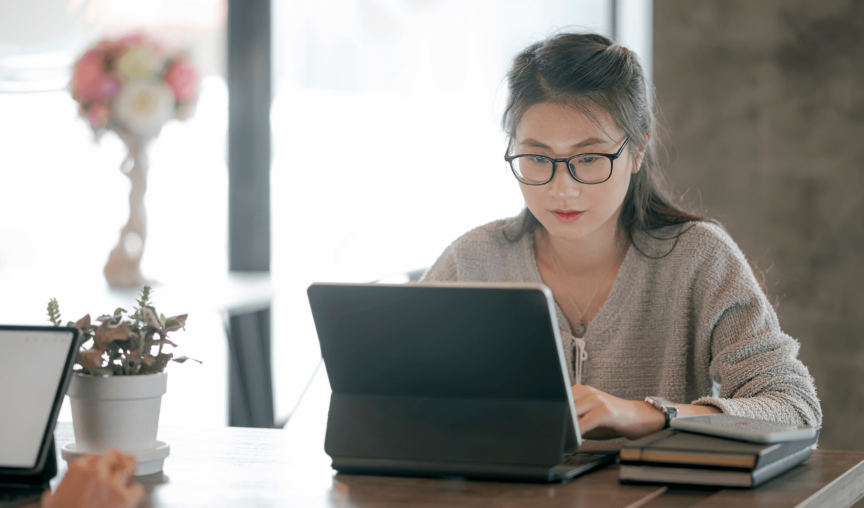 woman wearing glasses working at computer