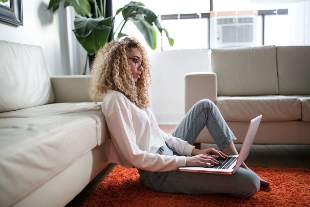 woman sitting checking her laptop