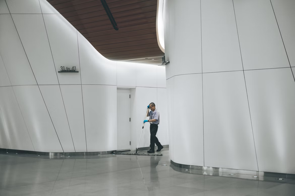 Cleaner mopping the floor in an office building