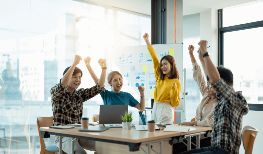 a group of colleagues cheering during an office meeting