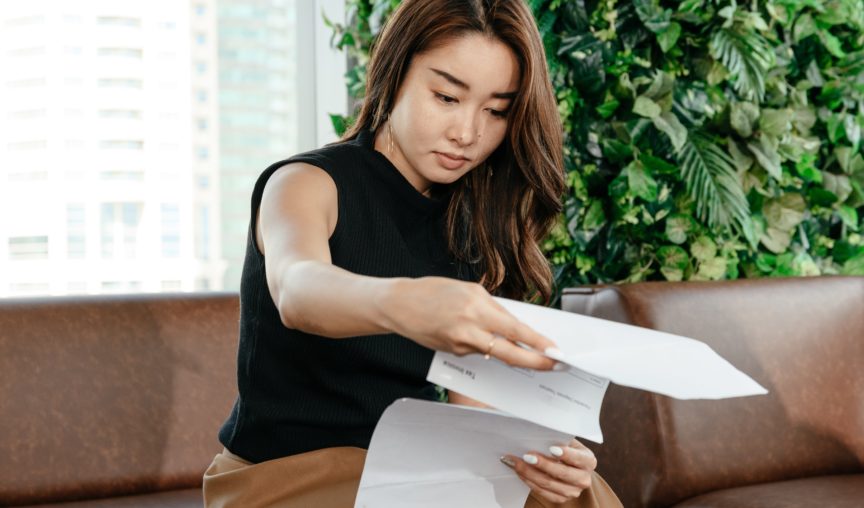 employee looking through a stack of papers