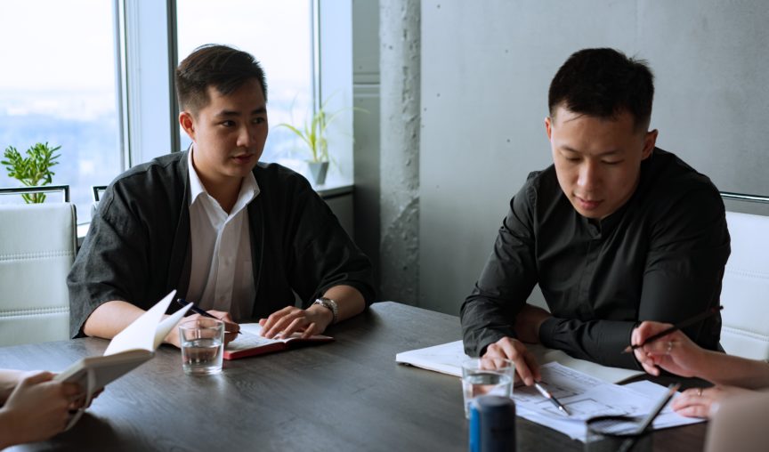 two employees in a meeting room having a discussion