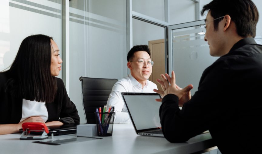 group of young colleagues having a discussion in a meeting room