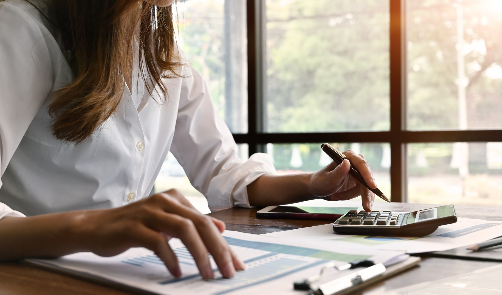 employee calculating numbers with a manual calculator