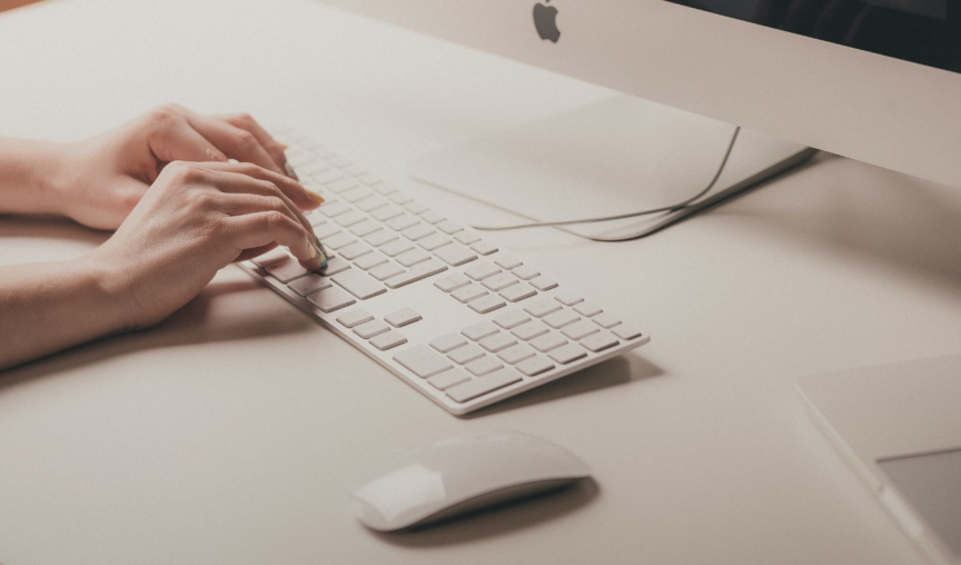Hands working at a computer