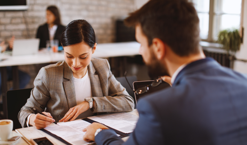 employee signing an agreement in front of manager