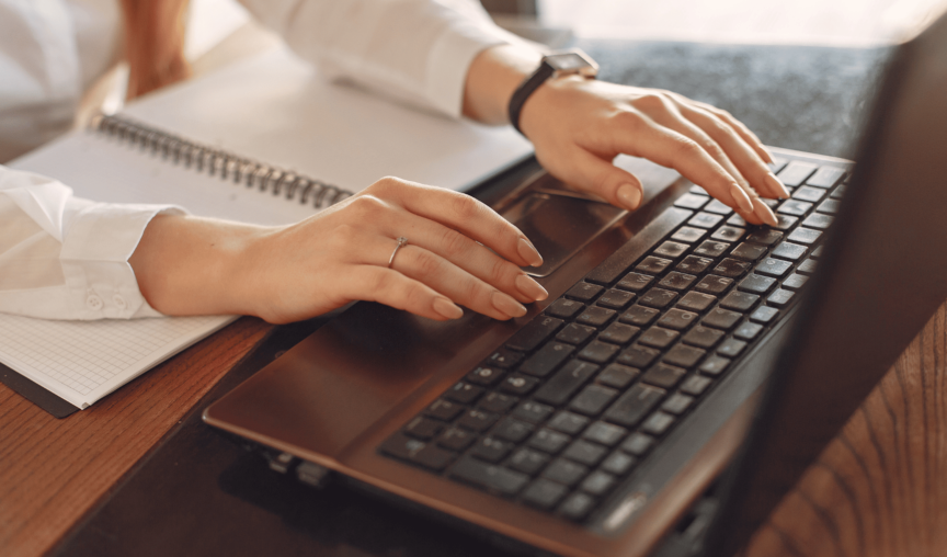 This is an image of a person typing at a computer.