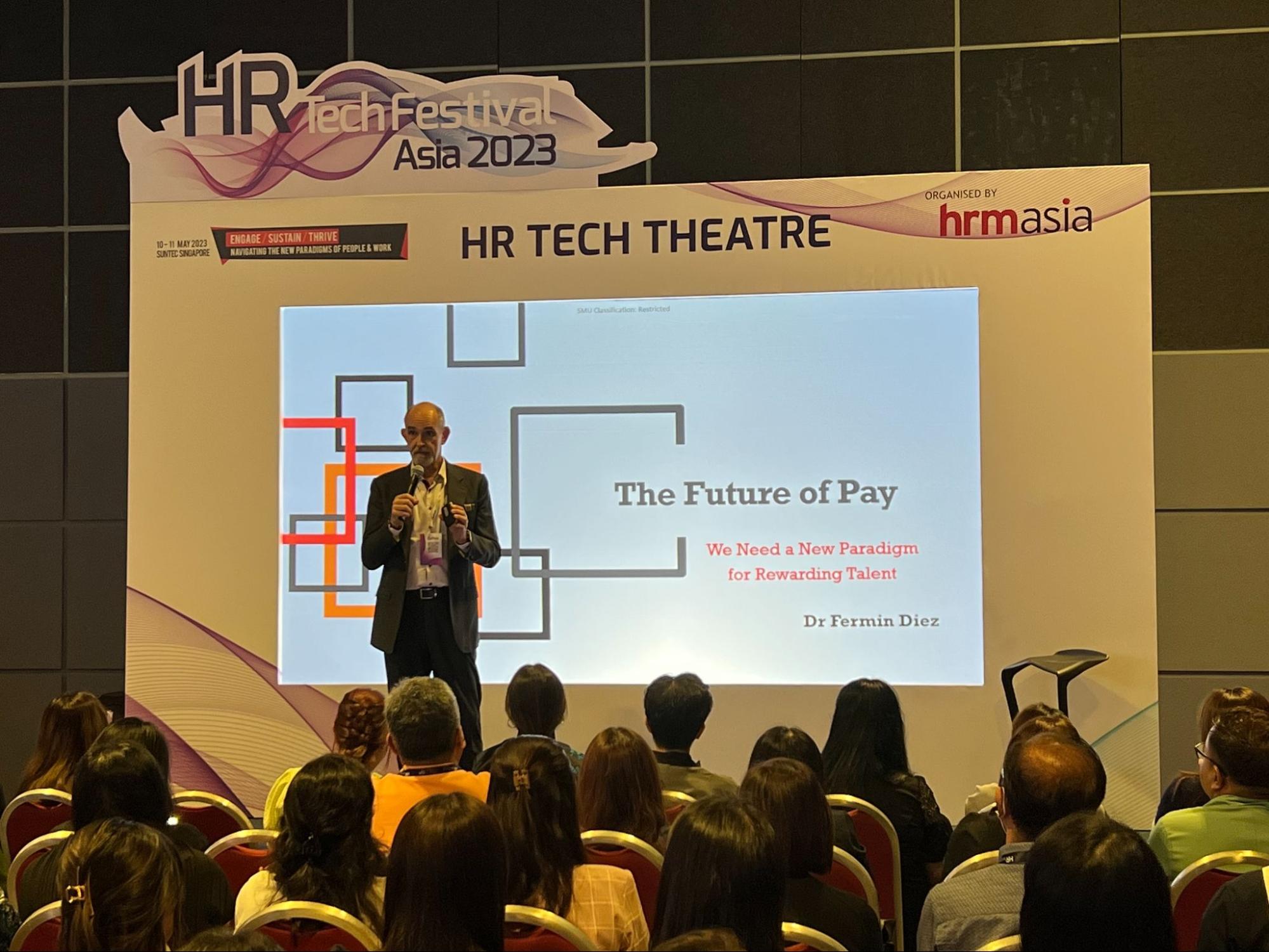 Dr Fermin Diez giving a speech on the future of pay