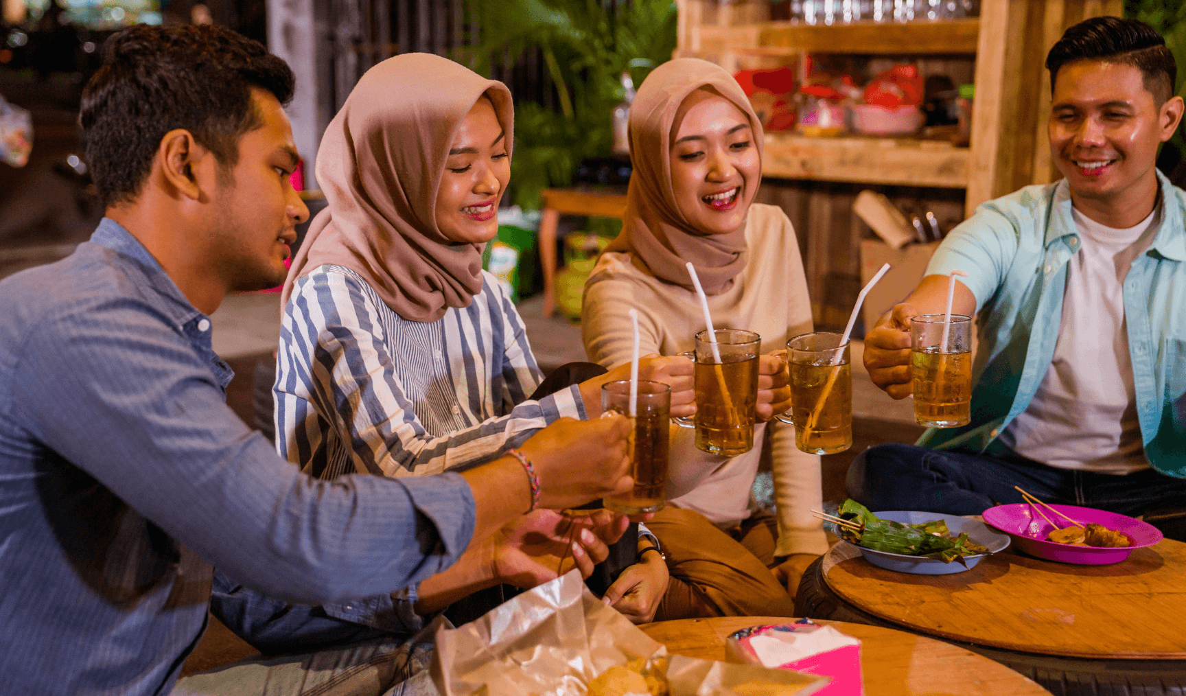 group of Muslim employees doing cheers with their drinks