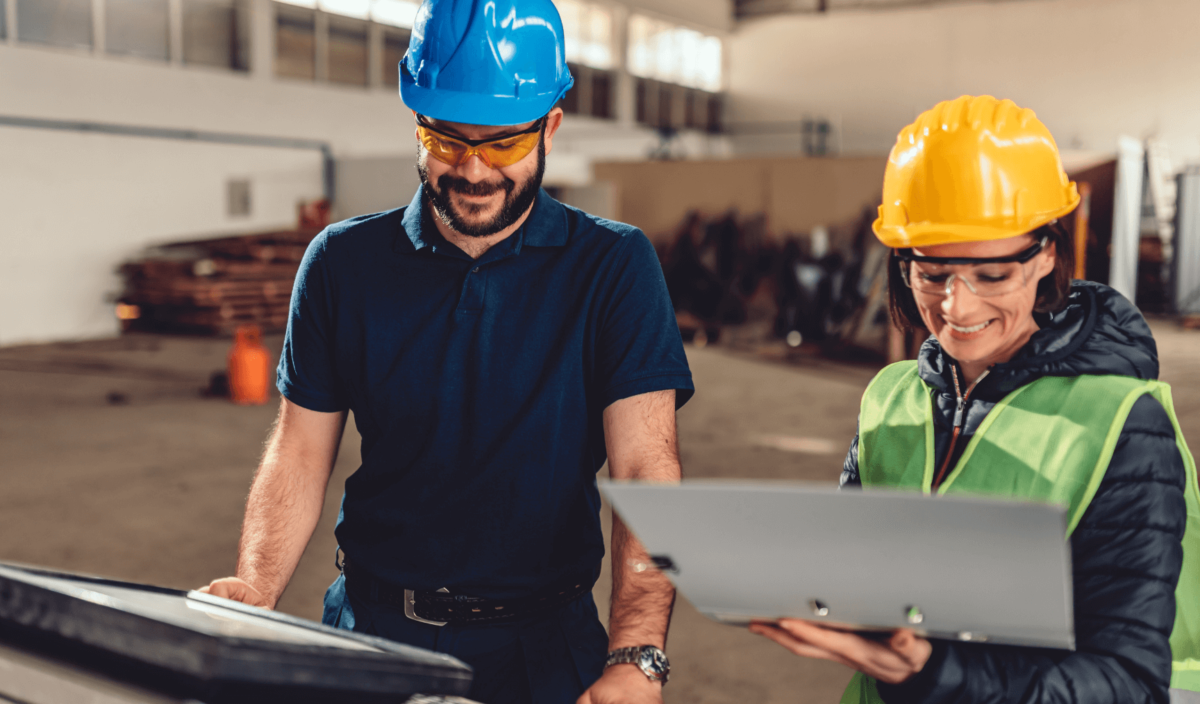 two colleagues in the warehouse looking at their clipboards