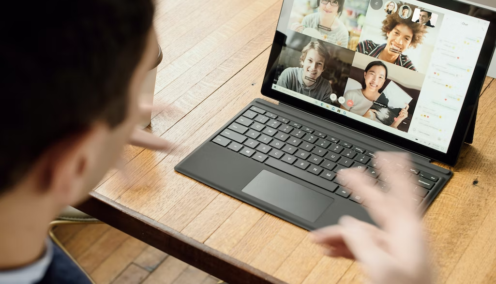 employee in a virtual meeting talking to his colleagues via a tablet
