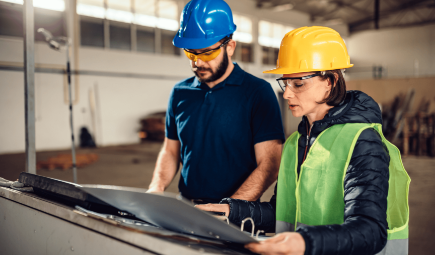 two employees in the warehouse analysing data