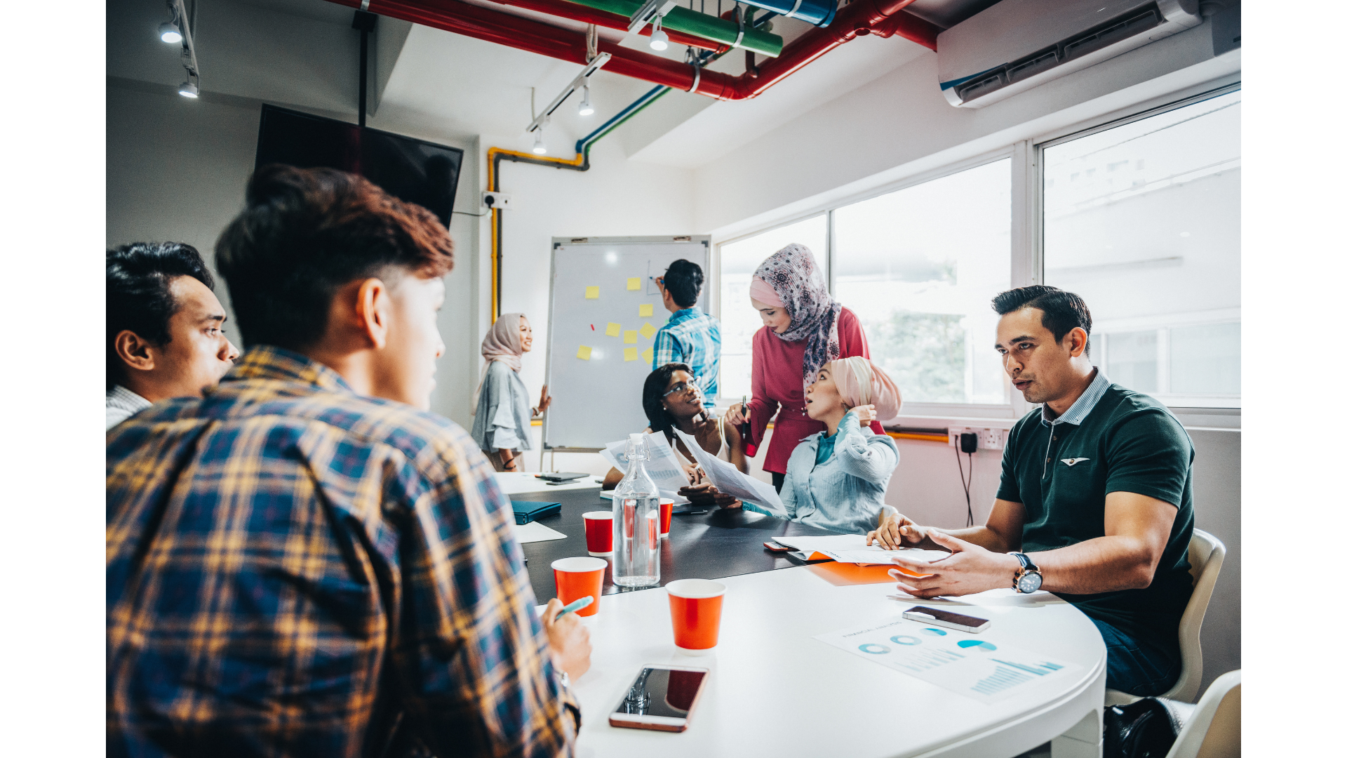 A team working at a round table on a project.