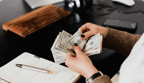 a woman handling money - federal budget