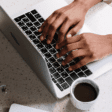 image of a person typing on a laptop